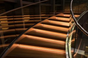 A glass staircase lit up by lights, representing the next steps you can take to pursue a career in the nuclear industry