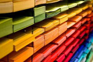 Stacks of colourful paper in a shelf