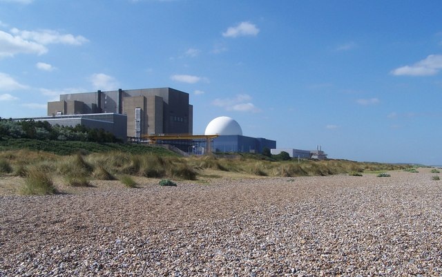 An image of Sizewell A, a first generation Magnox reactor, in front of Sizewell B, a Pressurised Water Reactor. With a shingle beach in the foreground.