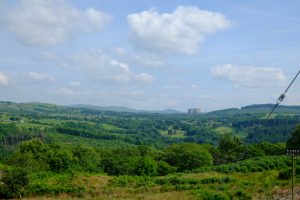 Trawsfynydd nuclear power station is visible in the distance across rolling hills covered in trees