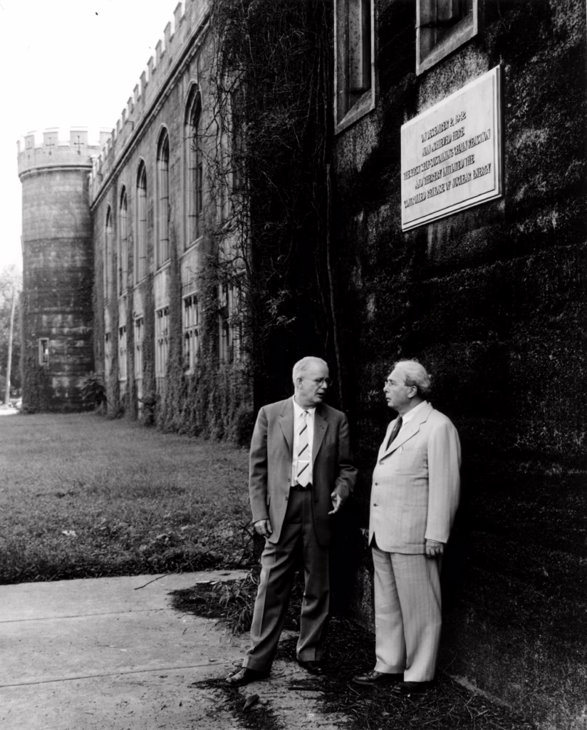 Dr. Norman Hilberry (left) and Dr. Leo Szilard at the site where the world's first nuclear reactor was built during World War II.