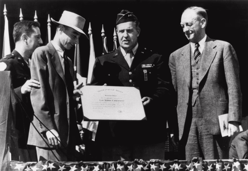 Leslie Groves, on behalf of the Los Alamos Laboratory, presents an award to Robert J. Oppenheimer, c. 1945